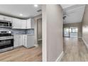 Stylish kitchen with modern white cabinets, stainless steel appliances, and a view of the adjacent living space at 1409 57Th W St # 1409, Bradenton, FL 34209
