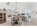 Dining room area featuring a round table, chandelier, and view into kitchen at 14257 Heritage Landing Blvd # 1122, Punta Gorda, FL 33955