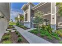 Exterior view of home showcasing sidewalk and well-maintained landscaping at 14257 Heritage Landing Blvd # 1122, Punta Gorda, FL 33955
