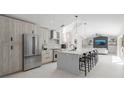 Modern kitchen with stainless steel appliances, a spacious island, and stylish light fixtures at 1527 Buoy Ln, Osprey, FL 34229