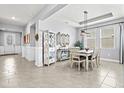 Open-concept dining area with modern decor, tile flooring, and seamless flow to the entryway and living spaces at 17547 Cantarina Cv, Bradenton, FL 34211