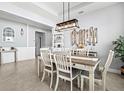 Well-appointed dining area with modern lighting, stylish furnishings, and a welcoming atmosphere for gatherings at 17547 Cantarina Cv, Bradenton, FL 34211