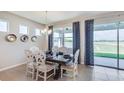 Elegant dining area with scenic backyard views and stylish decor offers a perfect space for gatherings at 17805 Pastureland Ave, Lakewood Ranch, FL 34211
