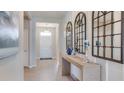 Inviting hallway featuring stylish decor, tiled floors, and a bright entryway, creating a welcoming atmosphere at 17805 Pastureland Ave, Lakewood Ranch, FL 34211