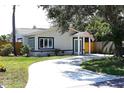 Inviting single-story home with a curved driveway and well-maintained lawn at 204 36Th W St, Bradenton, FL 34205