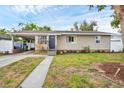 Lovely single-story home with a covered carport, green lawn and neatly trimmed landscaping at 2105 19Th W St, Bradenton, FL 34205