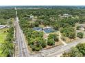 Real estate featuring a bright blue house, detached garage, pool, landscaping, and tree coverage at 2726 Desoto Rd, Sarasota, FL 34234