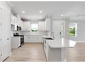 Bright kitchen with stainless steel appliances, white cabinets, and an island with bar seating at 3204 Torta Ct, Bradenton, FL 34211