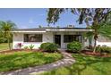 Charming home with fresh landscaping and a welcoming walkway leading to the front door and covered front porch at 326 25Th W St, Bradenton, FL 34205