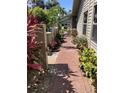 Brick paved walkway with lush landscaping and a view of neighboring homes at 3407 Avenida Madera # A, Bradenton, FL 34210