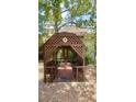 Inviting entrance to the home with a covered arbor, decorative lattice and brick pathway at 4042 S Lockwood Ridge Rd, Sarasota, FL 34231