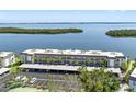 An aerial shot of a large condo complex, highlighting the parking and the close proximity to the water at 4310 Falmouth Dr # 307, Longboat Key, FL 34228