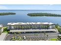 An aerial shot of a large condo complex, highlighting the parking and the close proximity to the water at 4310 Falmouth Dr # 307, Longboat Key, FL 34228