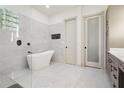 This stunning bathroom includes a soaking tub and a glass block window feature at 4696 Del Sol Blvd, Sarasota, FL 34243