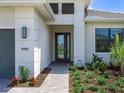 Inviting front entrance with decorative stone pathway, manicured landscaping, and an elegant black-framed door at 4988 Fairhope Cir, Lakewood Ranch, FL 34211