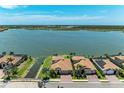 Stunning aerial view of the lakefront community with lush landscaping and pristine blue waters at 501 Maraviya Blvd, Nokomis, FL 34275
