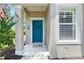 Close-up of the inviting front entrance with a vibrant blue door and charming details at 5047 Newport News Cir, Bradenton, FL 34211
