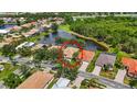 Aerial view of the home, highlighting the lush greenery and serene lake surroundings of the property's neighborhood at 5074 Flagstone Dr, Sarasota, FL 34238