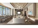 Stylish resident lounge with fireplace, TV, and views of the ocean at 555 Quay Cmn # 801, Sarasota, FL 34236