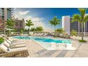 Resort-style pool area with lounge chairs, palm trees, and city skyline views at 555 Quay Cmn # 401, Sarasota, FL 34236