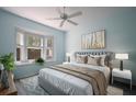 Relaxing bedroom featuring a large bed, bay window, and a soothing color palette at 656 Vallance Ne Way, St Petersburg, FL 33716