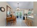 Cozy dining area with tile flooring, dining table, and access to the outdoors at 712 68Th W Ave, Bradenton, FL 34207