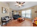 Comfortable living room with wood floors, ceiling fan, and natural light from the windows at 712 68Th W Ave, Bradenton, FL 34207