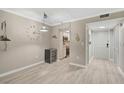 Bright dining area with wood floors, clock decor, and mini bar at 7211 Cloister Dr # 101, Sarasota, FL 34231