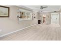 Spacious living room with wood flooring, ceiling fan, and lots of natural light at 7211 Cloister Dr # 101, Sarasota, FL 34231