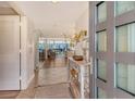 Inviting entryway featuring tile floors, console table, and mirrored wall leading to the living area at 1115 Gulf Of Mexico Dr # 304, Longboat Key, FL 34228