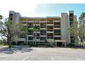 Exterior of a multi-story condo building with multiple balconies and well-maintained landscaping at 1115 Gulf Of Mexico Dr # 304, Longboat Key, FL 34228
