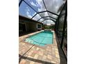 Inviting screened-in pool area with spa and brick paver surround at 119 Maraviya Blvd, Nokomis, FL 34275