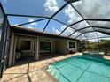 Screened-in pool area with a brick patio, spa, and plenty of room for relaxing at 119 Maraviya Blvd, Nokomis, FL 34275