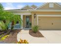 Inviting home facade featuring a covered entry, manicured landscaping, and a warm, welcoming ambiance at 12327 Halfmoon Lake Ter, Bradenton, FL 34211