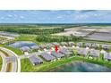 Aerial view of a residential community with serene lake and green expanses, showcasing a peaceful neighborhood at 12743 Tahitian Pearl Cir, Parrish, FL 34219