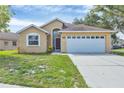 Welcoming single-story home with a well-maintained lawn, and an attached two-car garage, offering a blend of comfort and style at 1451 Fawnwood Cir, Sarasota, FL 34232