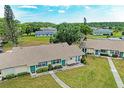 An aerial shot of a charming home, showcasing its well-manicured lawn, quaint exterior, and neighborhood at 1906 Canterbury Ln # 16, Sun City Center, FL 33573