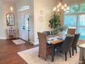 Elegant dining room features modern lighting, a table for six, and views of the entry at 2149 Muskogee Trl, Nokomis, FL 34275