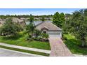 An aerial view of a lovely home with pristine landscaping, a brick driveway and a lake in the backyard at 2334 50Th Street E Cir, Palmetto, FL 34221