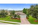 Beautiful single-story home featuring a two-car garage, stone accents, and lush landscaping at 2334 50Th Street E Cir, Palmetto, FL 34221