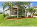Charming house featuring stone accents, well-maintained landscaping, and a lush green lawn at 2334 50Th Street E Cir, Palmetto, FL 34221