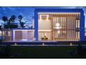 Modern residence featuring clean lines, a cascading water feature, a private pool, and lush tropical landscaping at 2470 Ringling Blvd, Sarasota, FL 34237