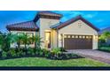 Charming single-story home with a well-manicured lawn and a two-car garage at 26687 Raphis Royale Blvd, Englewood, FL 34223