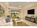 Cozy living room featuring a sliding glass door leading to an outdoor patio at 26687 Raphis Royale Blvd, Englewood, FL 34223