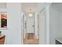 Bright hallway with ceramic floors, modern lighting fixture, and closet space at 2906 63Rd W St # 206, Bradenton, FL 34209