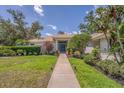 Charming home with a well-maintained lawn, mature landscaping, and a welcoming front entrance at 2914 Dick Wilson Dr, Sarasota, FL 34240