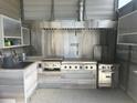 Well-equipped outdoor kitchen featuring stainless steel appliances at 3060 Courtland St, Sarasota, FL 34237