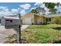 Quaint single-story home with an attached garage, well-maintained lawn, and welcoming curb appeal at 4076 Vana Dr, Sarasota, FL 34241