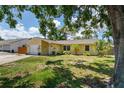 Inviting single-story home with a well-kept lawn, featuring an attached garage and neat landscaping at 4076 Vana Dr, Sarasota, FL 34241