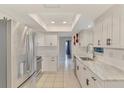 Bright kitchen featuring white cabinets, stainless steel appliances, and modern countertops at 4155 Center Gate Blvd, Sarasota, FL 34233